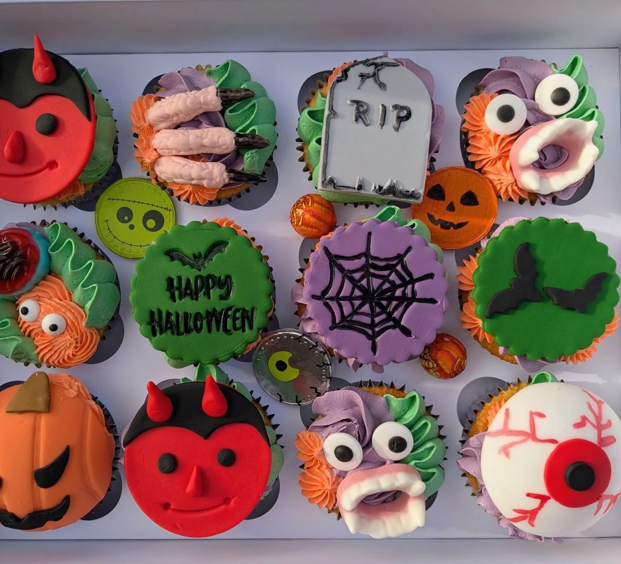 Halloween cupcakes with pumpkins, spiders and monsters